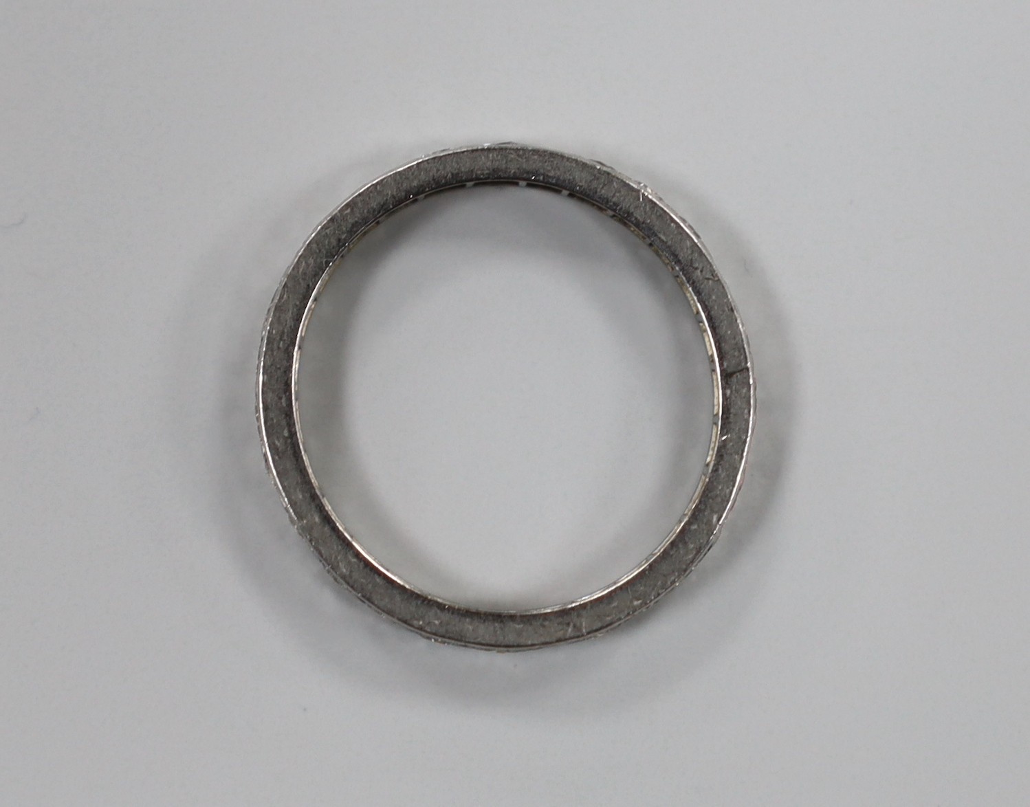 A white metal and diamond set full eternity ring, size N, gross weight 3 grams.